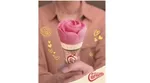 Woman holding the distinctive pink rose-shaped Cornetto Rose cone